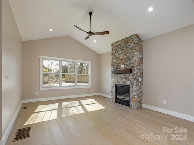 unfurnished living room featuring a fireplace, light hardwood / wood-style floors, ceiling fan, and lofted ceiling