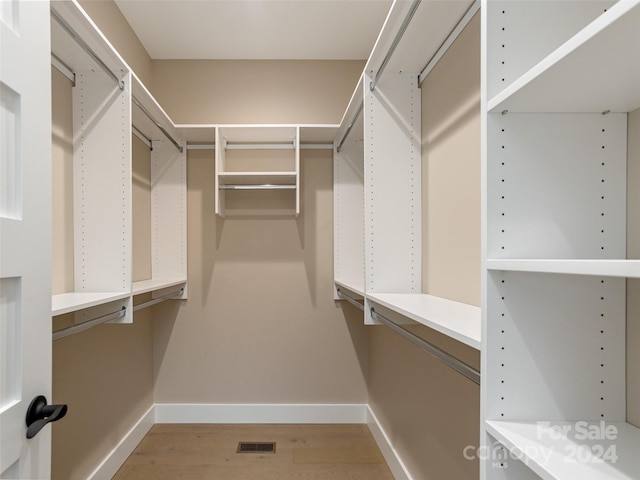 walk in closet featuring light hardwood / wood-style flooring