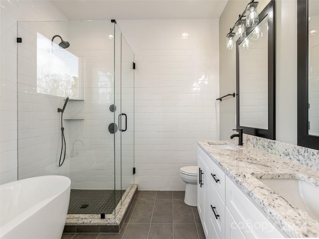 full bathroom with tile patterned floors, vanity, toilet, and separate shower and tub