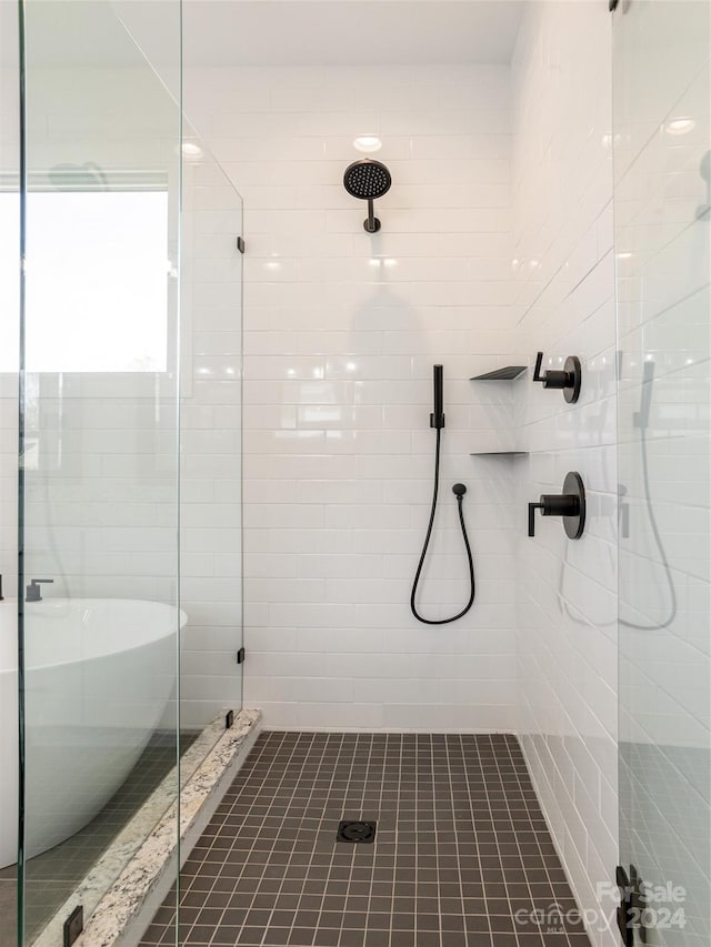 bathroom with tile patterned floors and a shower with shower door