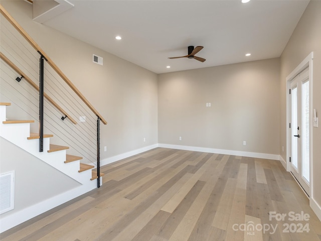 empty room featuring french doors, light hardwood / wood-style flooring, and ceiling fan