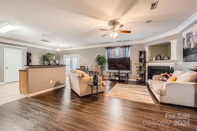 living room featuring ceiling fan, dark hardwood / wood-style flooring, french doors, and ornamental molding