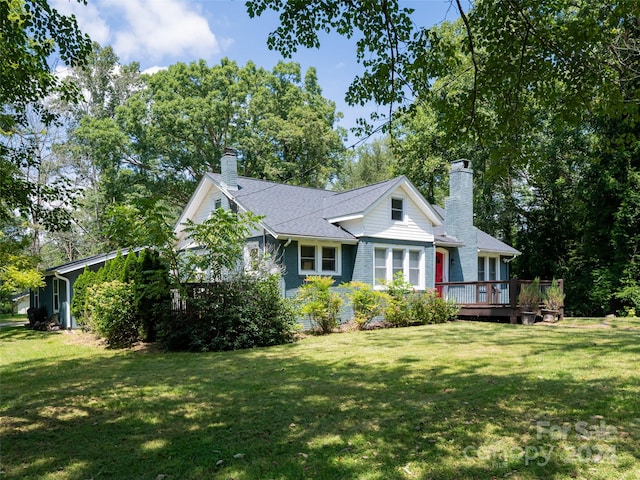 view of front of home featuring a front yard and a deck