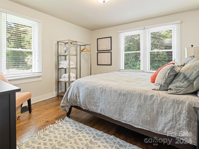 bedroom featuring hardwood / wood-style floors and multiple windows