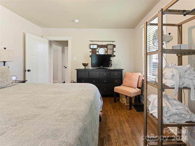 bedroom with dark hardwood / wood-style floors