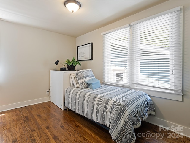 bedroom with dark hardwood / wood-style floors