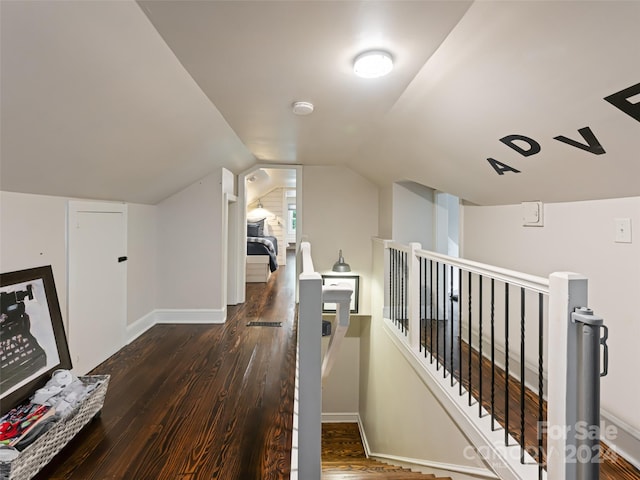 interior space with dark hardwood / wood-style flooring and lofted ceiling