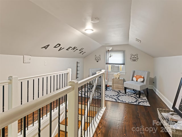 corridor with hardwood / wood-style floors, cooling unit, and vaulted ceiling