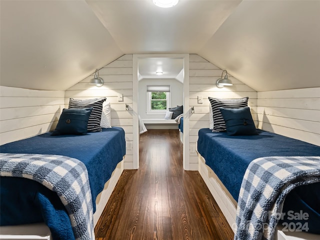 bedroom featuring dark wood-type flooring, wooden walls, and vaulted ceiling