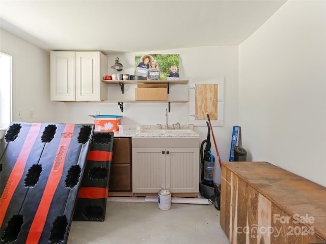 clothes washing area with sink