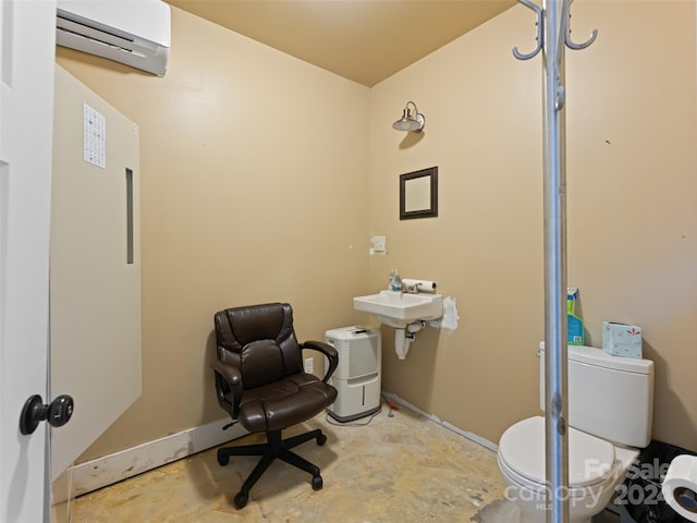 bathroom with toilet, concrete flooring, and a wall mounted air conditioner