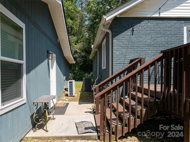 exterior space with central AC and a wooden deck