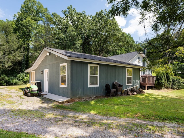 exterior space with a wooden deck and a yard