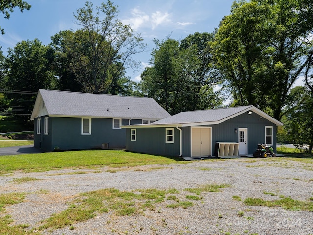 rear view of house with a yard