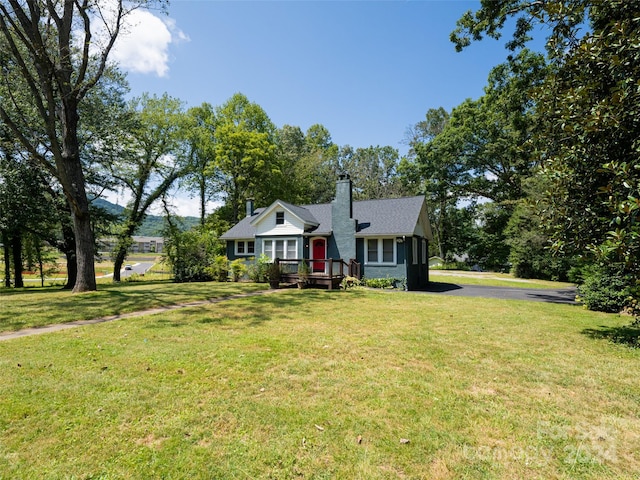 view of front of home with a front lawn and a deck