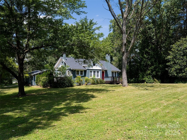 view of front of house with a front lawn and a wooden deck