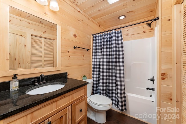 full bathroom with shower / tub combo, vanity, wooden walls, wooden ceiling, and toilet