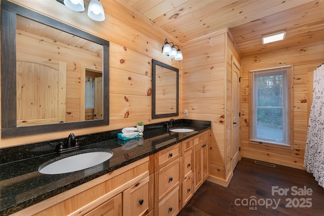 bathroom featuring vanity, wooden walls, hardwood / wood-style floors, and wood ceiling