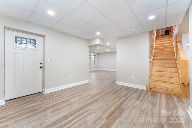 entrance foyer with a drop ceiling and light hardwood / wood-style flooring