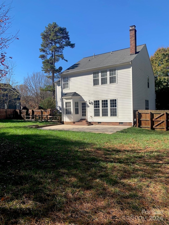 back of house featuring a patio area and a yard