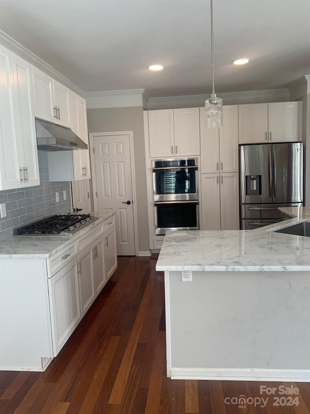 kitchen featuring light stone countertops, stainless steel appliances, dark hardwood / wood-style flooring, pendant lighting, and white cabinets