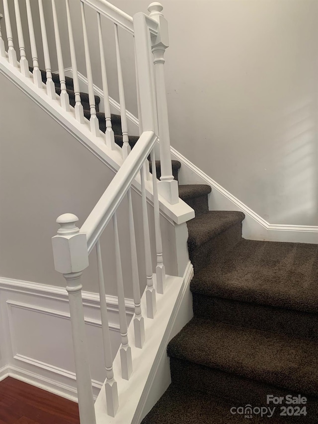 stairs with hardwood / wood-style floors