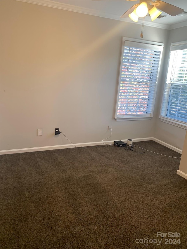 carpeted spare room featuring ceiling fan and crown molding