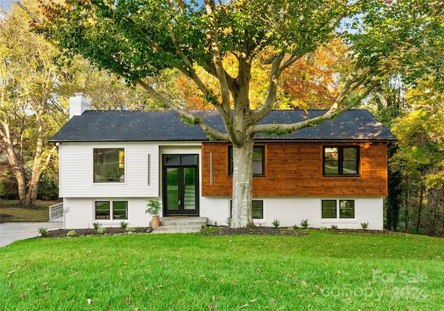 view of front of house with french doors and a front yard