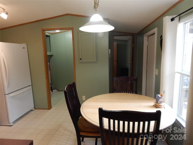 dining space with crown molding and lofted ceiling