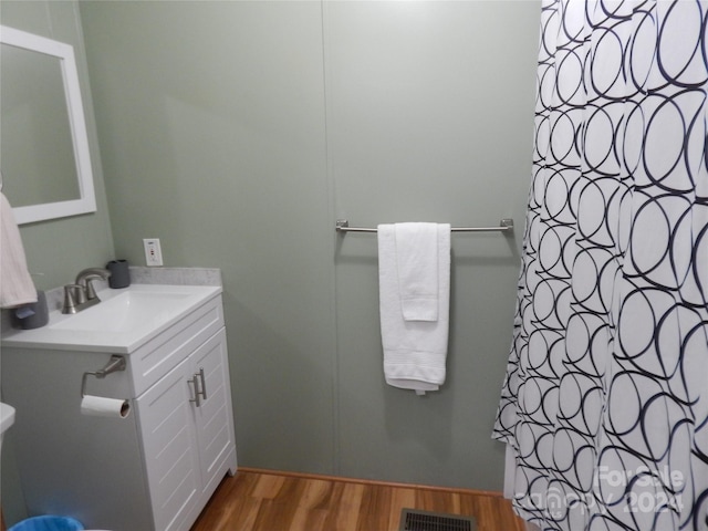 bathroom with vanity and hardwood / wood-style flooring