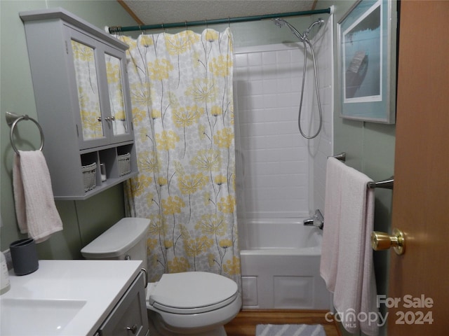 full bathroom with a textured ceiling, shower / bath combo with shower curtain, wood-type flooring, vanity, and toilet