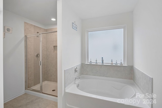 bathroom featuring plus walk in shower and tile patterned floors