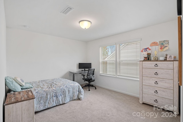 bedroom featuring light carpet