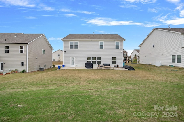 back of property featuring a lawn, a patio area, and cooling unit