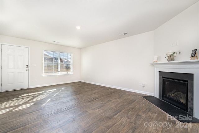 unfurnished living room with dark wood-type flooring