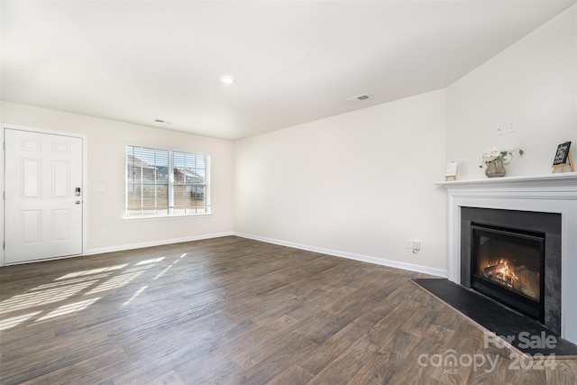 unfurnished living room with dark hardwood / wood-style flooring