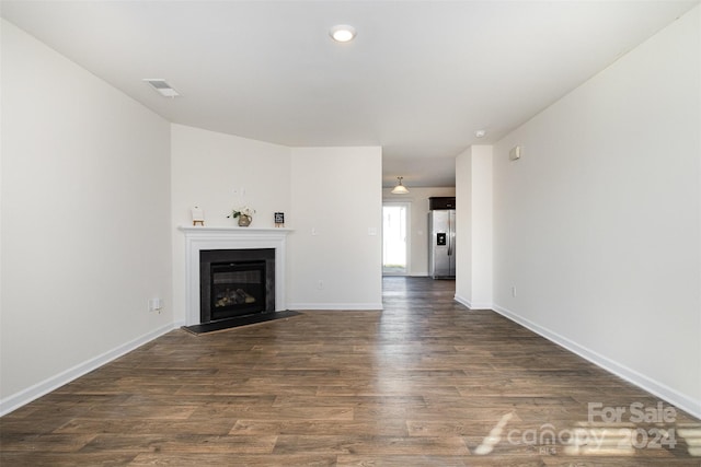 unfurnished living room featuring dark hardwood / wood-style flooring