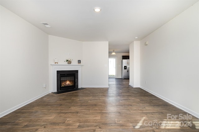 unfurnished living room featuring dark hardwood / wood-style flooring