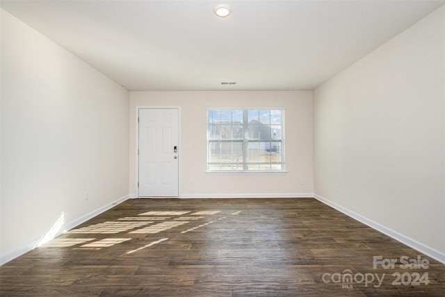 empty room featuring dark hardwood / wood-style flooring