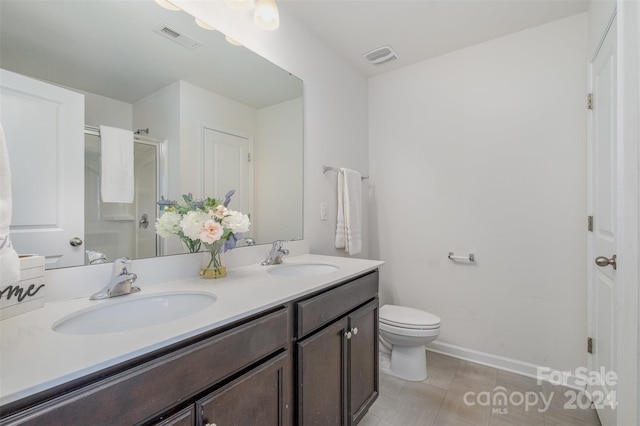 bathroom featuring walk in shower, tile patterned floors, vanity, and toilet