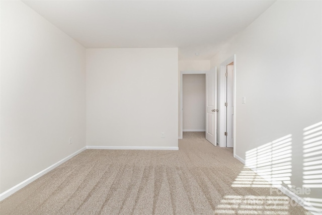 empty room featuring light carpet