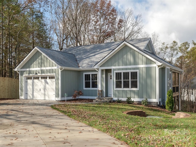 view of front of property with a garage and a front lawn