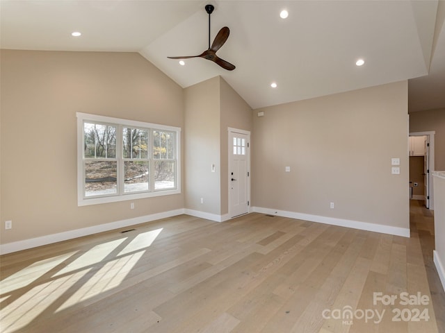 unfurnished living room featuring light wood-type flooring, ceiling fan, and high vaulted ceiling