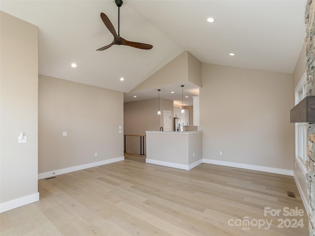 unfurnished living room with high vaulted ceiling, ceiling fan, and light hardwood / wood-style floors