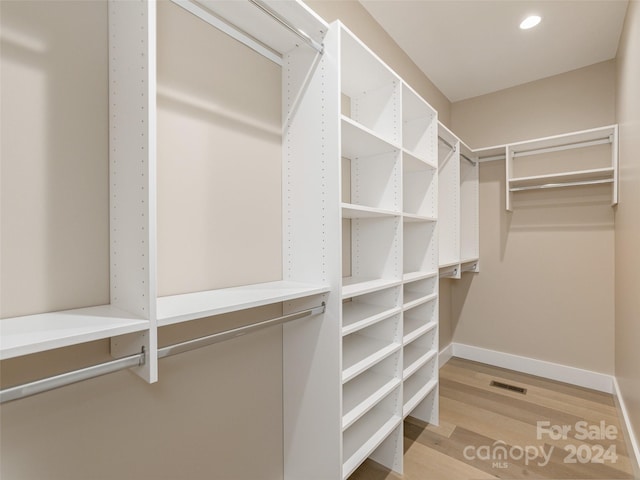 spacious closet featuring light hardwood / wood-style flooring