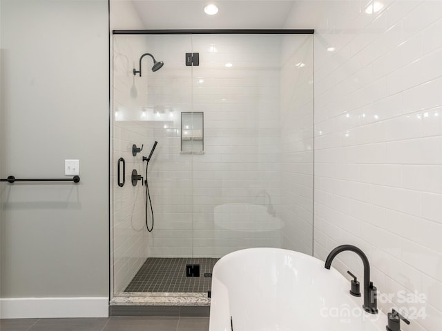 bathroom featuring tile patterned floors and independent shower and bath