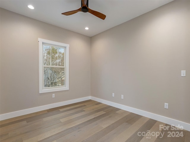 empty room with light wood-type flooring and ceiling fan