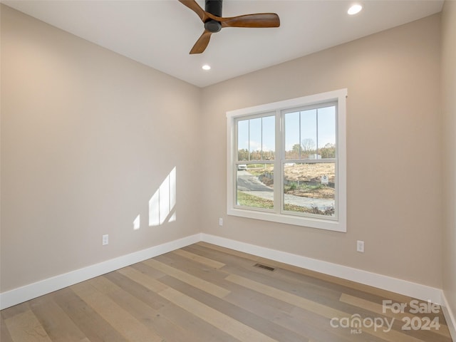 unfurnished room featuring hardwood / wood-style flooring and ceiling fan