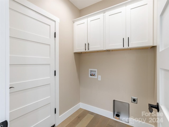 washroom with light wood-type flooring, electric dryer hookup, cabinets, and washer hookup