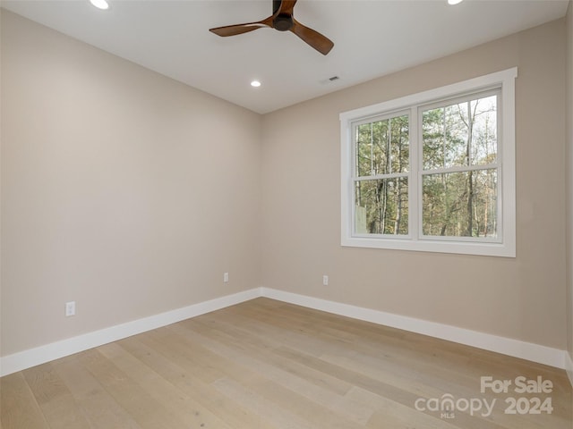 spare room with ceiling fan and light hardwood / wood-style flooring